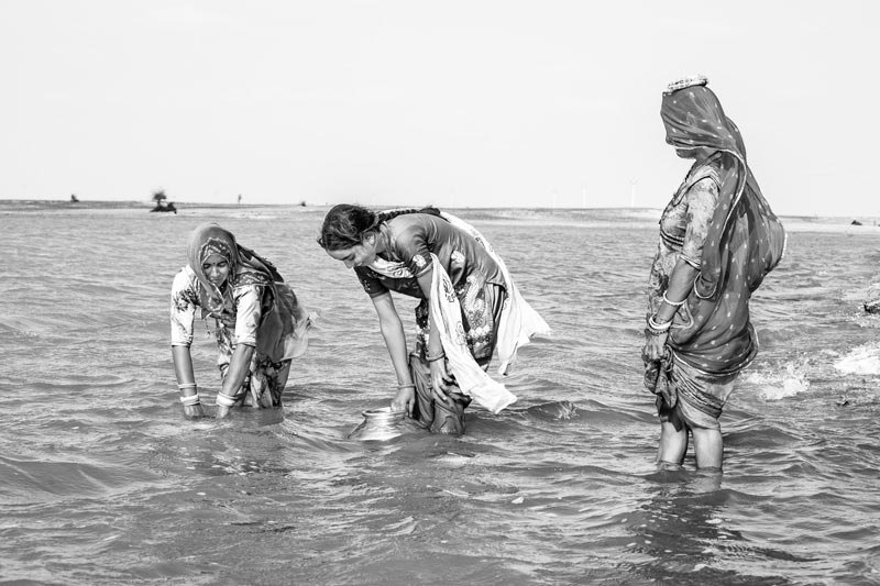 Nature-based solution for quenching thirst in the driest place of India - Drinking  water being filled into pots at Viprasar, a rainfed pond in Thar Desert, Jaisalmer district, Rajasthan